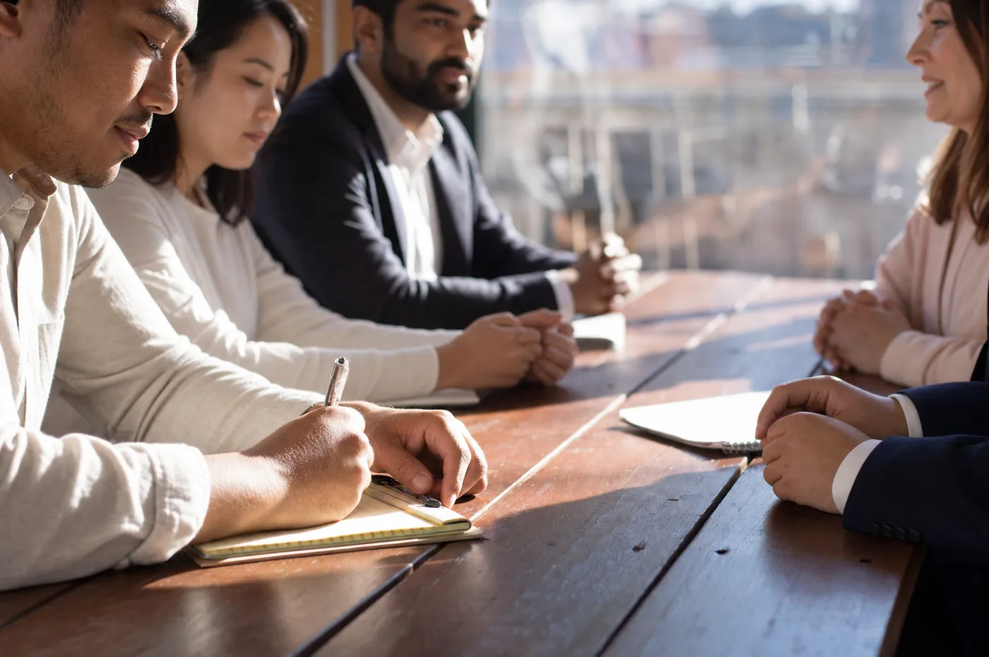 A diverse team of business professionals working through a session around a table